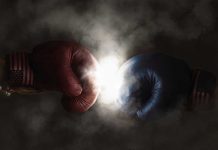 Red and blue boxing gloves clashing with smoke.