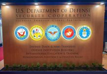 U.S. Department of Defense Security Cooperation display with logos.