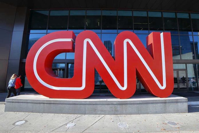Large red CNN sign outside building entrance.