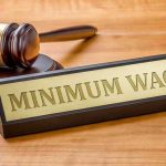 DEOMCRAT Freshman Drops $25 Wage Bombshell Minimum Wage sign next to judges gavel.