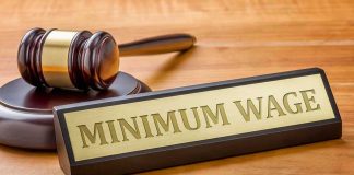 Minimum Wage sign next to judges gavel.
