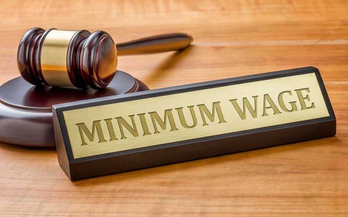 Minimum Wage sign next to judges gavel.