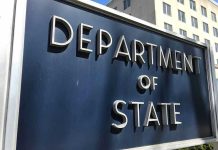 Department of State sign in front of building.