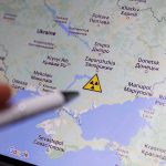 Map of Ukraine with nuclear warning symbol.