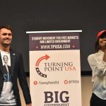 Kirk’s Juggernaut Moves Gen Z Right Curro Savoy at a TPUSA event with another speaker on stage